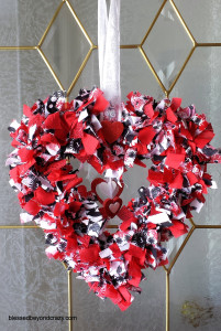 Pink and white Valentine's Day Rag Wreath on a glass window.