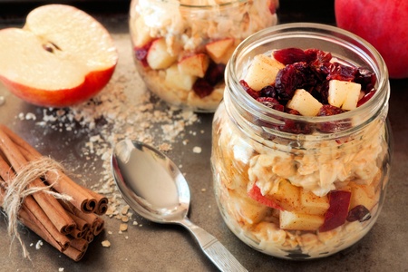 46077754 - autumn overnight oats with apples and cranberries in a mason jar on vintage metal background