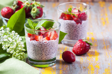 Chia Pudding in small glasses with sliced strawberries on top.