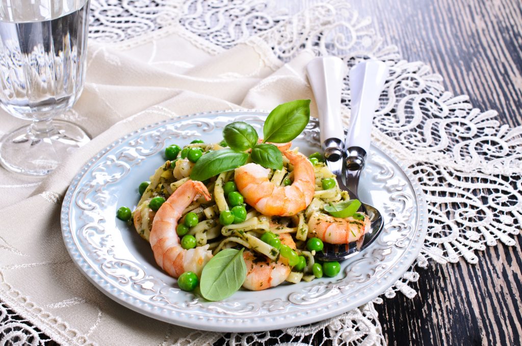 Pasta tagliatelle with shrimp and peas, dressed with sauce "pesto"