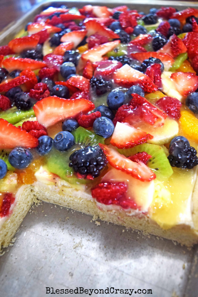 Cut view of The Ultimate Loaded Fruit Pizza, sugar cookies