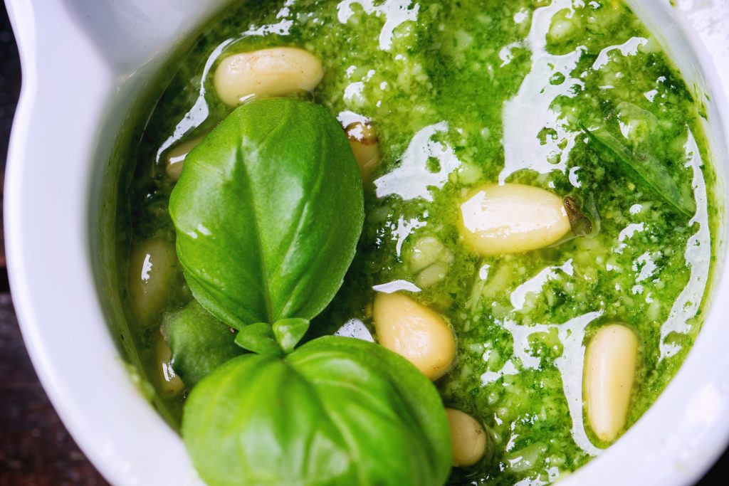 Close up of homemade pesto sauce with basil and pine nuts