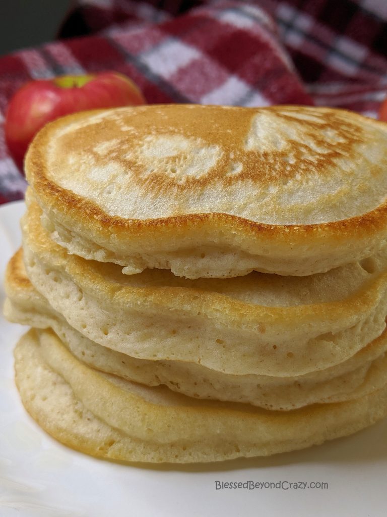 Tall stack of Sticky Cinnamon Apple Pecan Pancakes