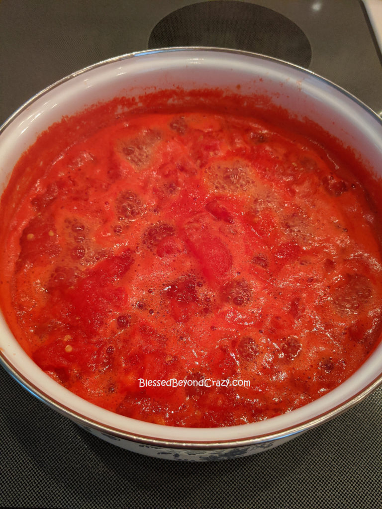 Cooking tomatoes in order to make Homemade Sausage Tomato Soup (Gluten-Free Option) 
