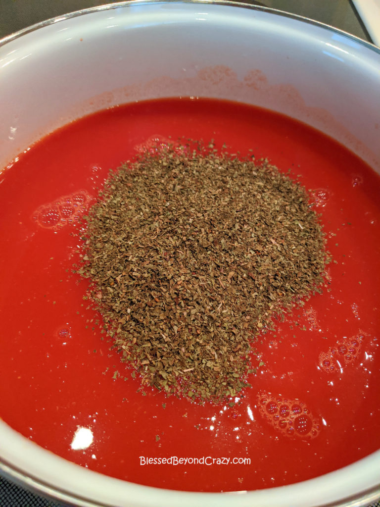 Adding herbs to Homemade Sausage Tomato Soup (Gluten-Free Option)