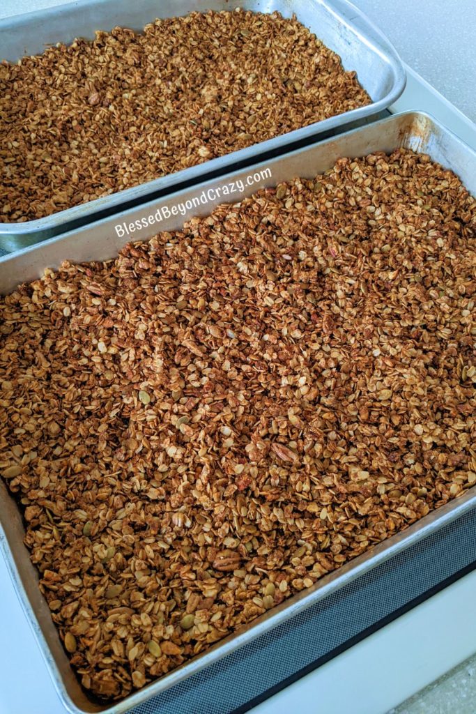 Two large baking pans with freshly baked homemade granola.