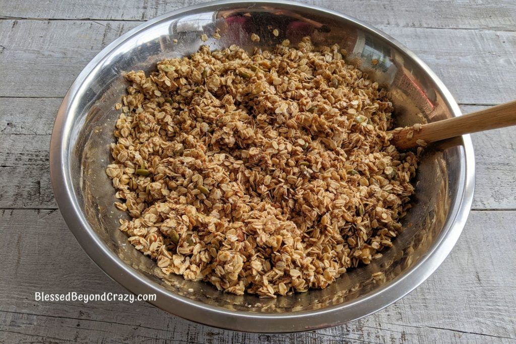 Large bowl of unbaked homemade nutty high fiber granola ready to bake.
