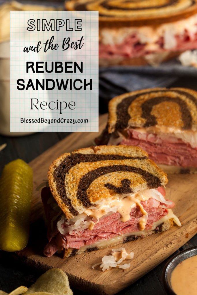 Pinterest image of a delicious Reuben sandwich cut in half and ready to eat.