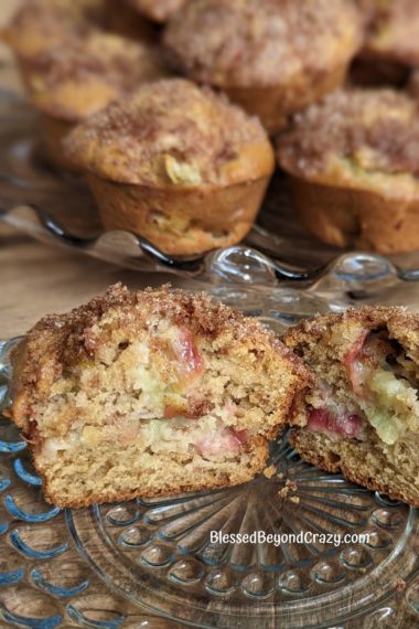 Small serving plate with individual rhubarb muffin cut in half.
