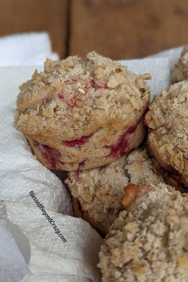 Raspberry Streusel Muffin close up showing the raspberries peaking through
