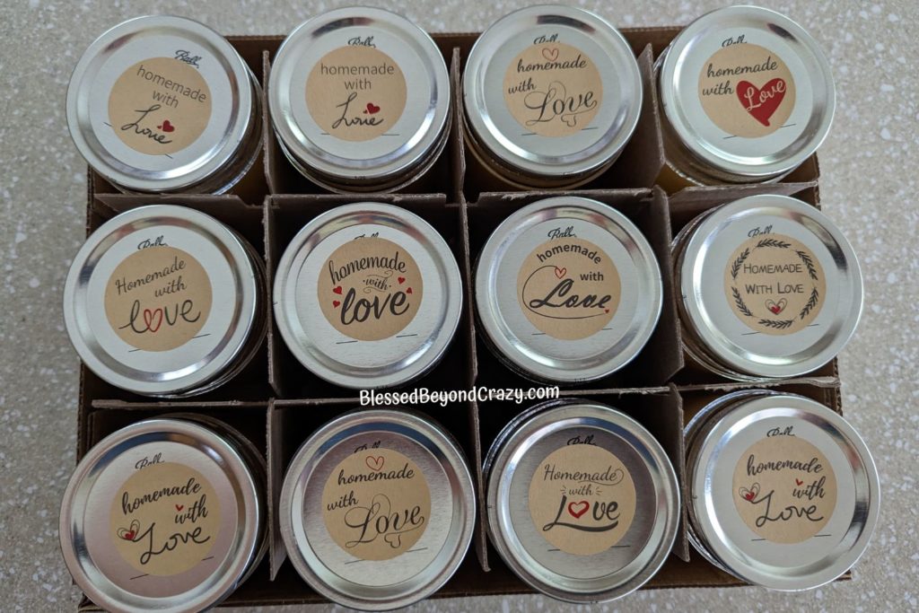 Overhead view of jars of Pear Honey Jam with cute stickers that say, "Homemade with Love" on them.