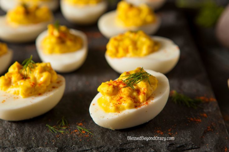 Close up view of deviled eggs on a slate platter