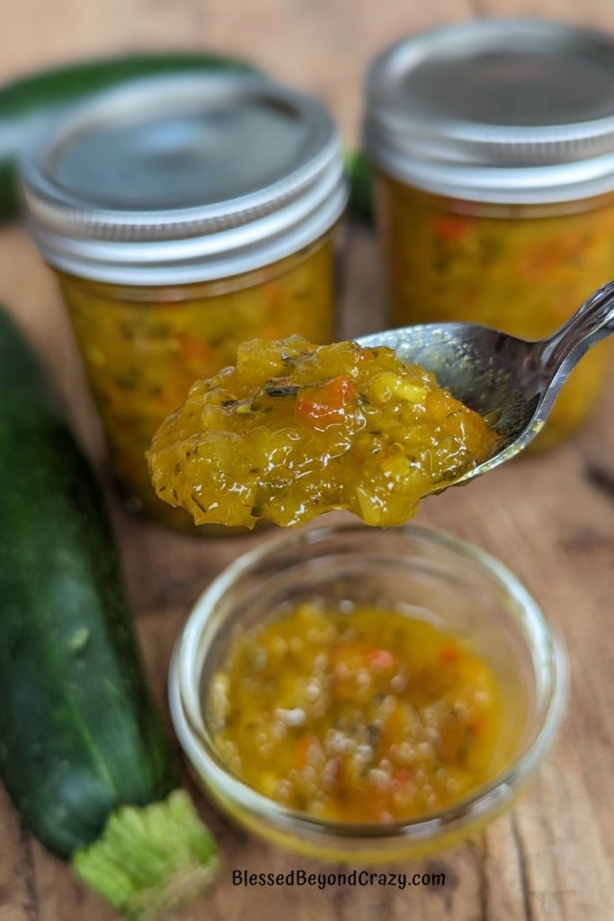 Close up view of spoonful of zucchini relish.