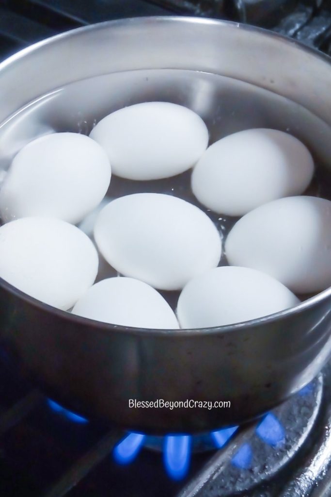Pan of eggs boiling in hot water