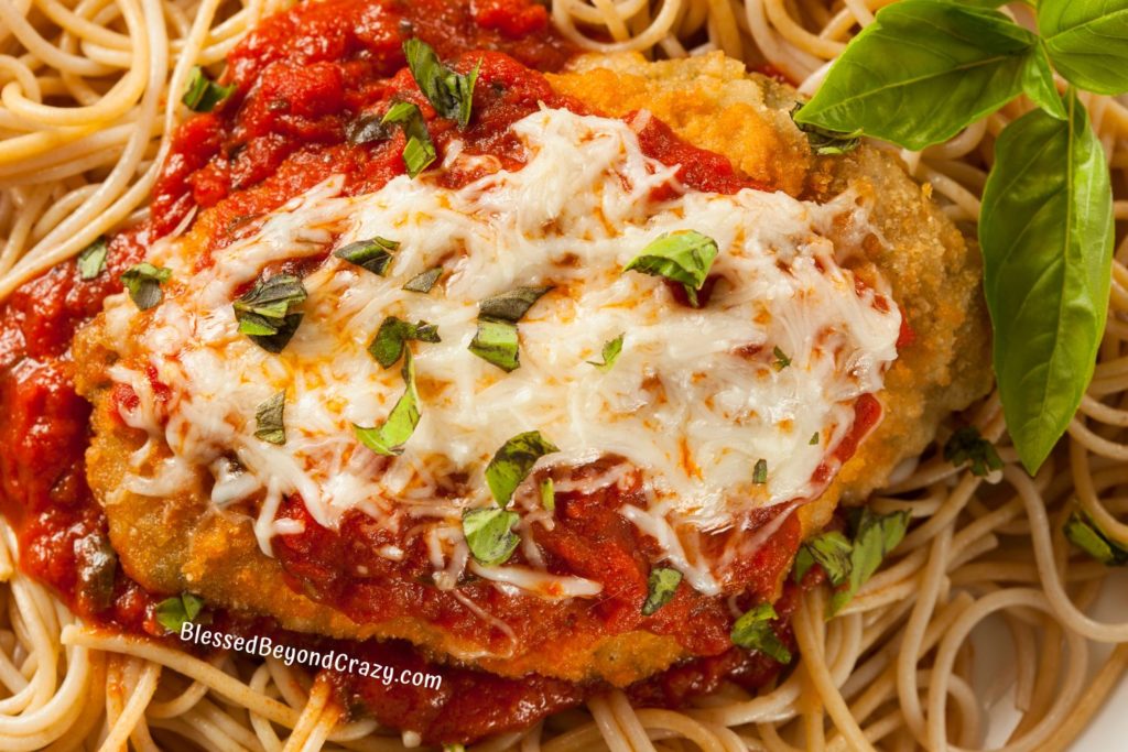 Close up overhead view of delicious serving of chicken parmesan.