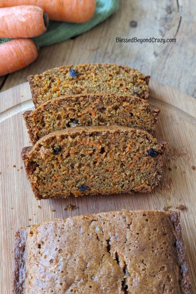 Overhead view of three slices of freshly baked carrot bread.