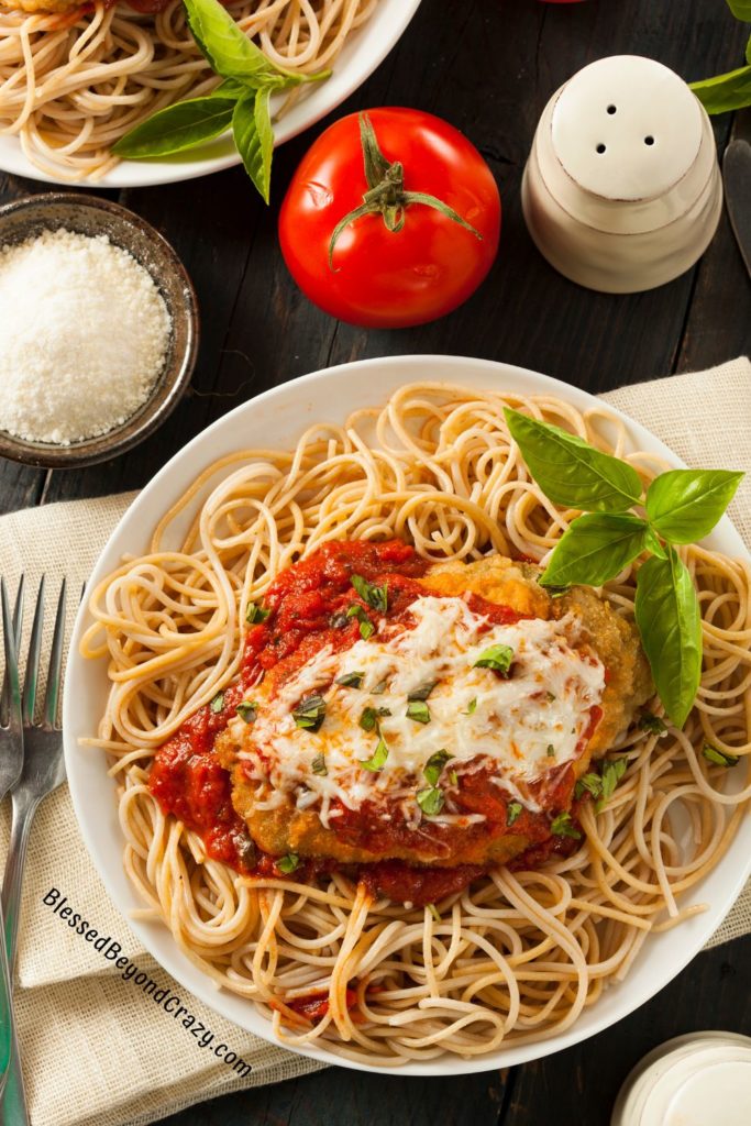 Overhead view of plate full of ready-to-eat chicken parmesan.
