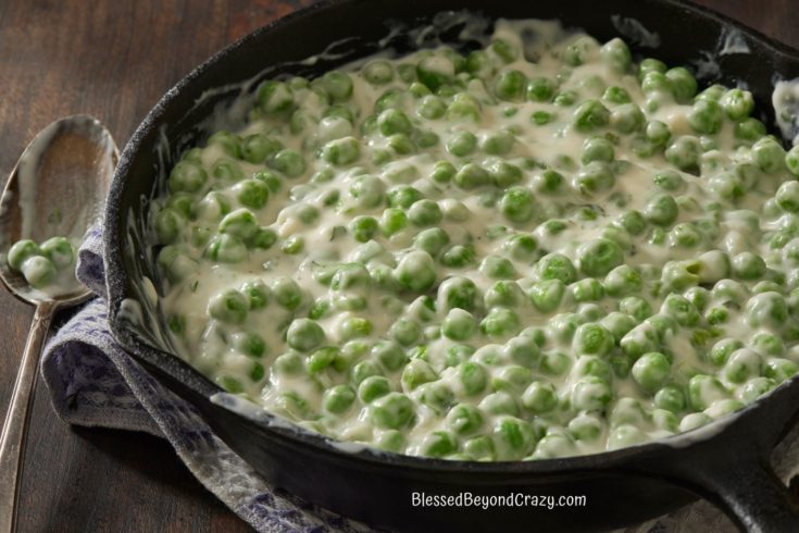 Cast Iron skillet with freshly made batch of creamed peas.