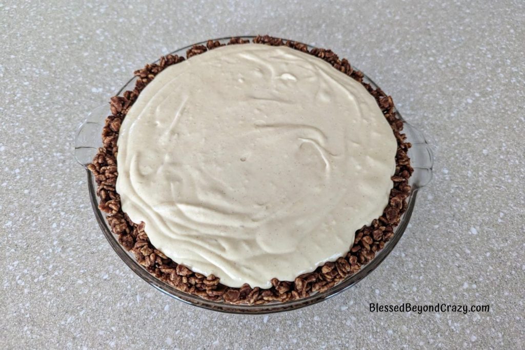 Overhead view of creamy peanut butter filling inside Rice Krispie crust.