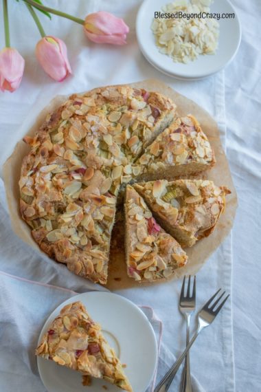 Rhubarb and Almond Coffee Cake with individual serving on plate.