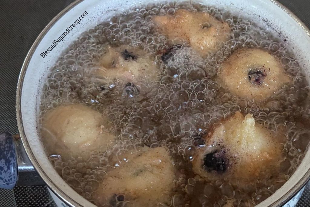 Blueberry Fritters frying in hot oil