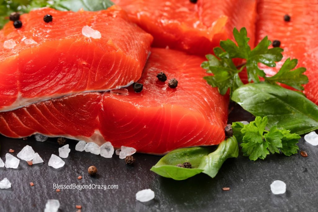 Close up photo of fresh Sockeye Salmon steaks with herbs and spices.