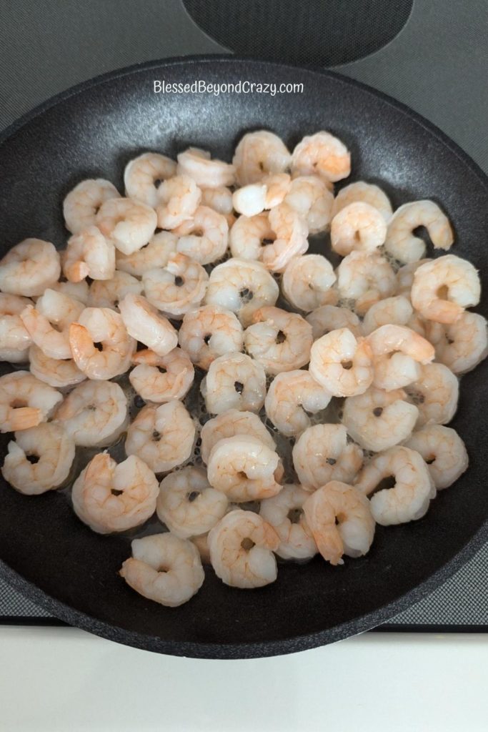 Shrimp sautéing in a skillet