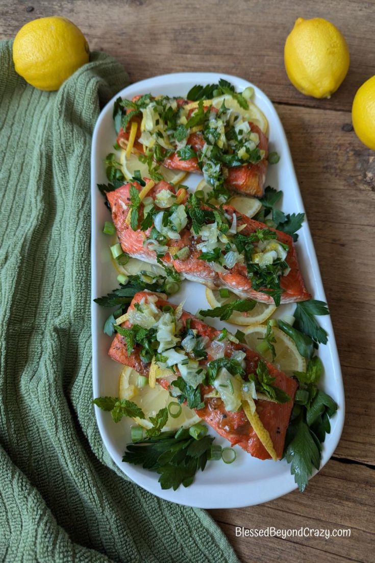 Overhead photo of platter with freshly broiled salmon and lemon salsa.