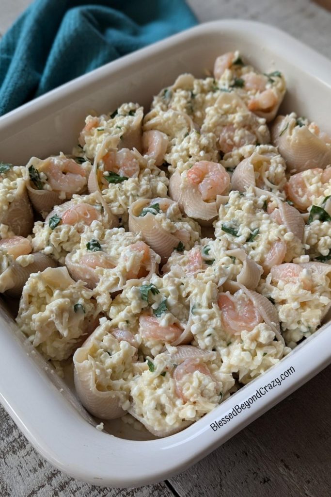 Cooked jumbo shells filled with a mixture of seafood, ricotta cheese and parsley.