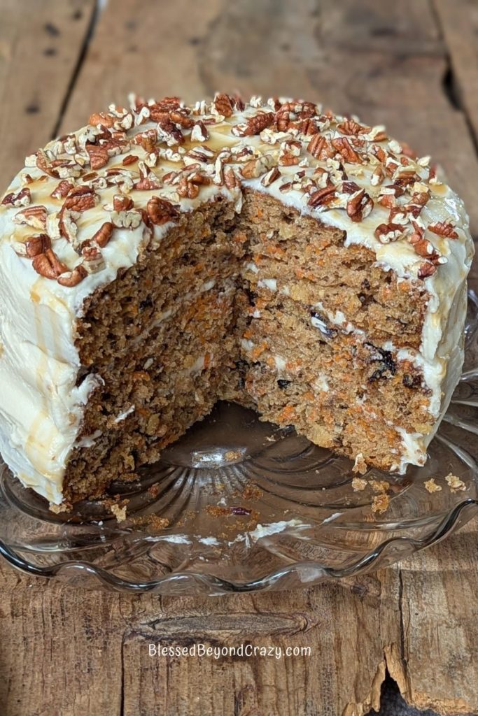 Whole carrot cake minus two slices cut out.