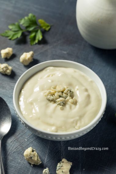 Vertical photo of a bowl of blue cheese dressing.