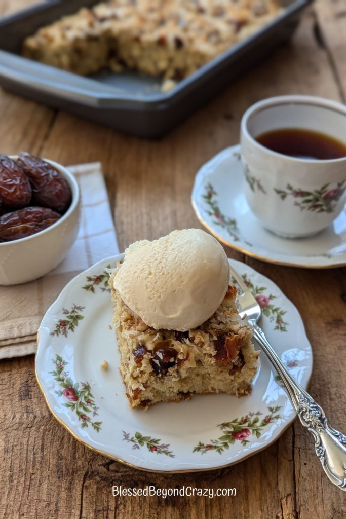 Serving of coffee cake with scoop of vanilla ice cream on top.