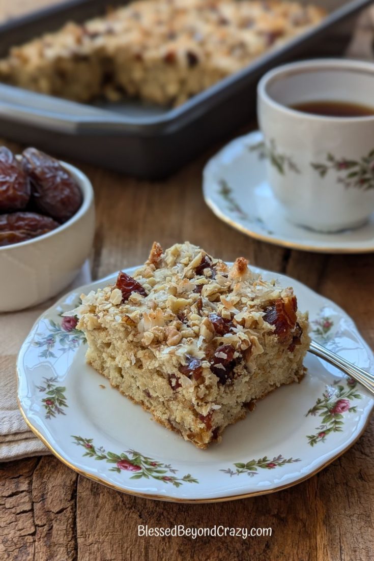 Ready to eat serving of Medjool Date Coffee Cake with cup of hot tea.