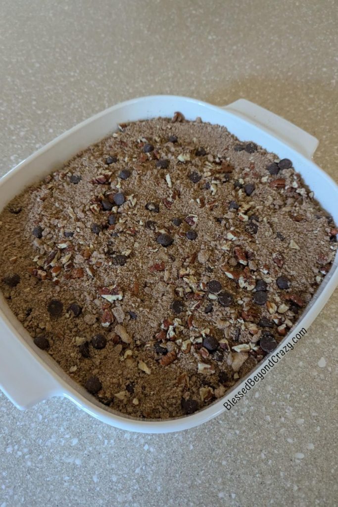 Overhead photo of streusel topping covering coffee cake, ready to bake.