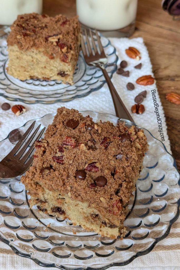 Overhead view of two servings of coffee cake with two glasses of milk.