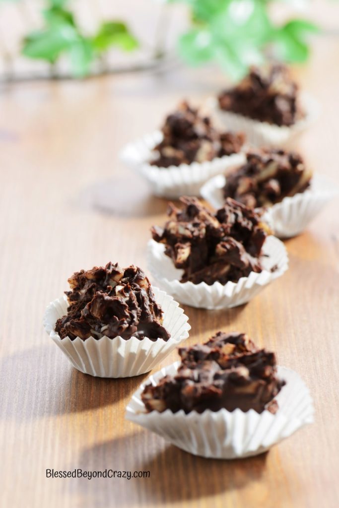 Vertical photo of homemade chocolate candies in individual mini muffin papers.