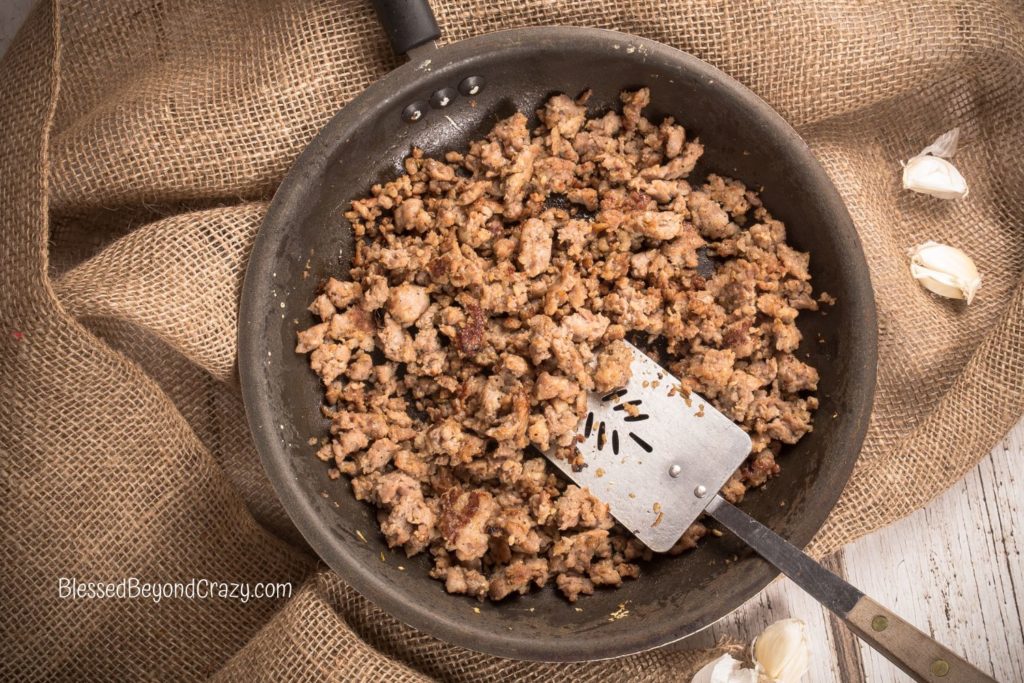 Overhead photo of skillet with cooked ground meat.