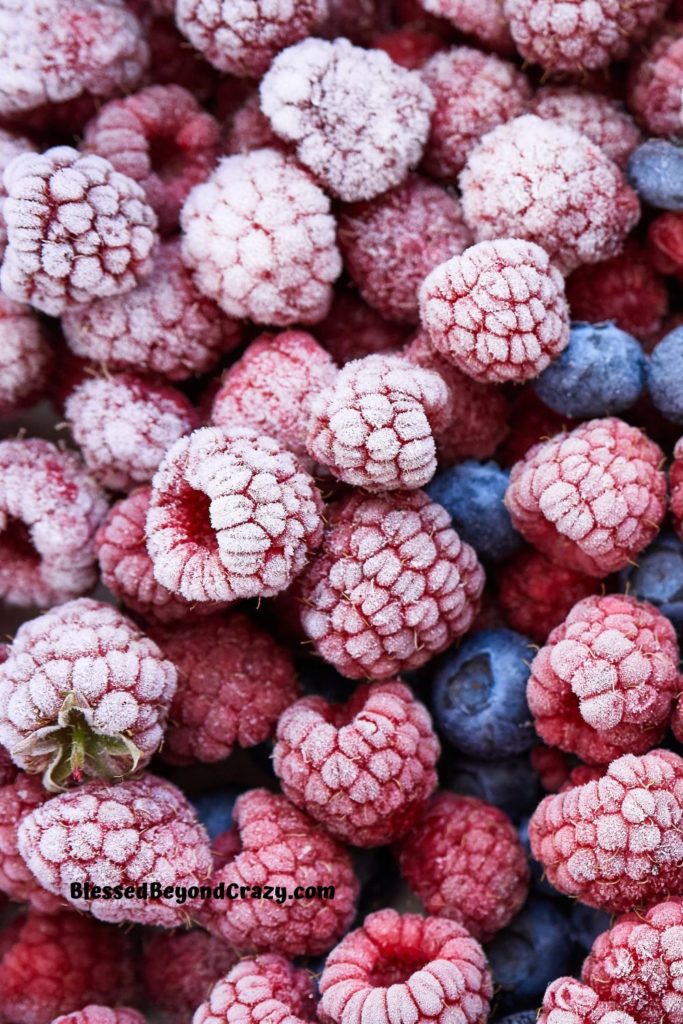 Overhead photo of frozen raspberries and blueberries.