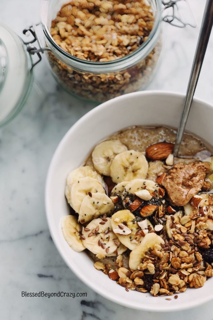 Overhead photo of a bowl of cereal with bananas and almonds.