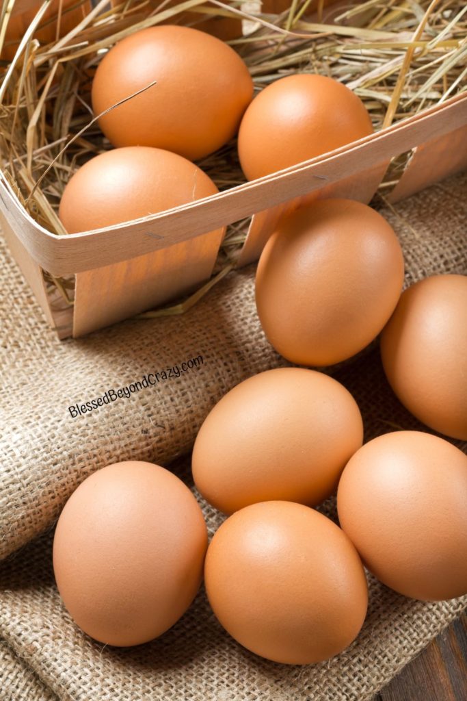 Photo of fresh brown eggs on burlap and in basket.