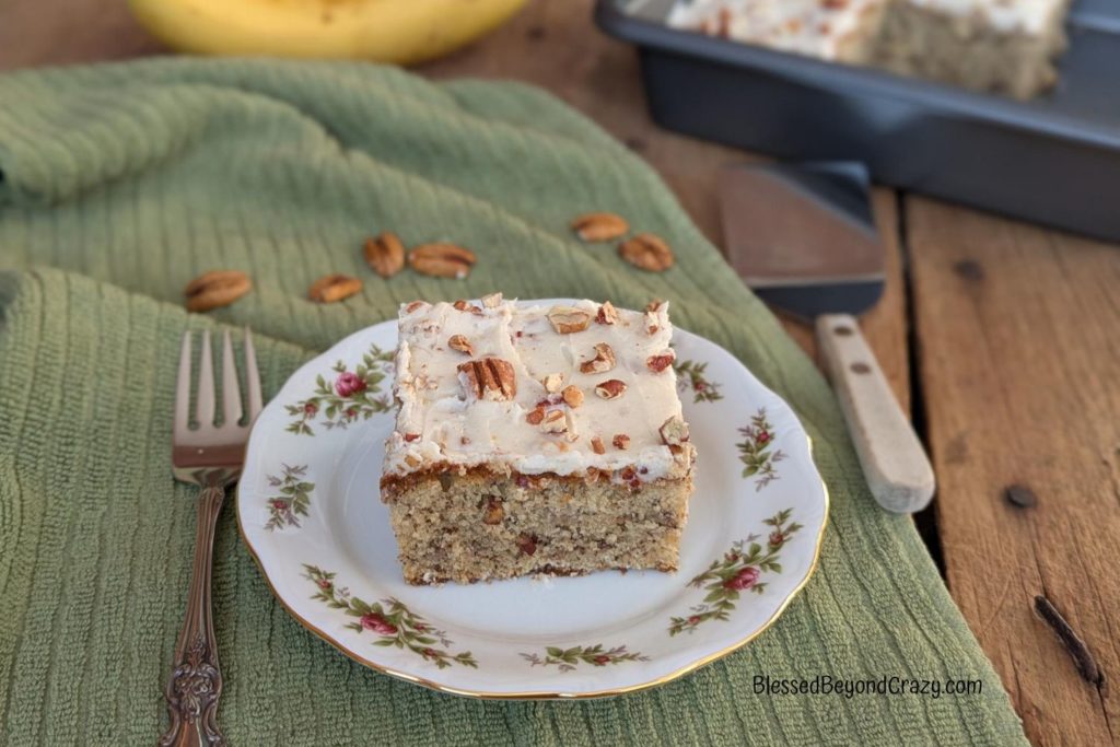 Vertical view of individual serving of banana pecan cake.