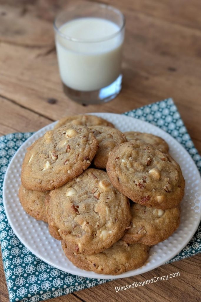 Overhead view of plate of cookies and small glass of milk.