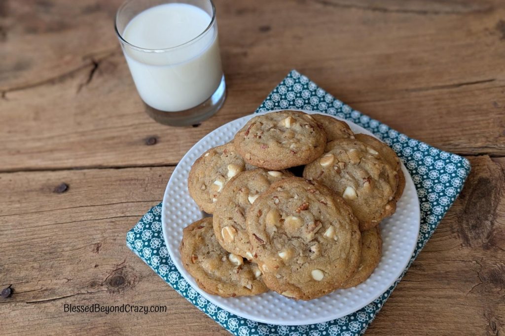 Overhead horizontal photo of a plate with cookies and glass of milk.