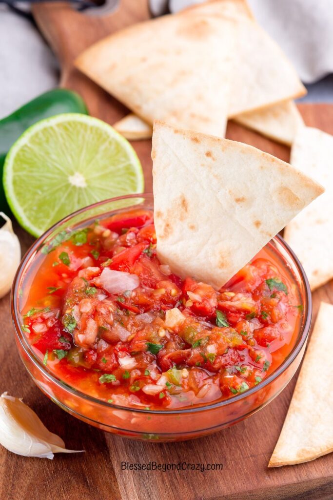 Overhead photo of bowl of salsa with nacho chip in the bowl