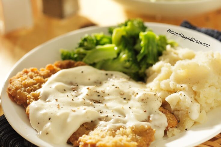 Ready to eat chicken fried steak and gravy, mashed potatoes and broccoli.